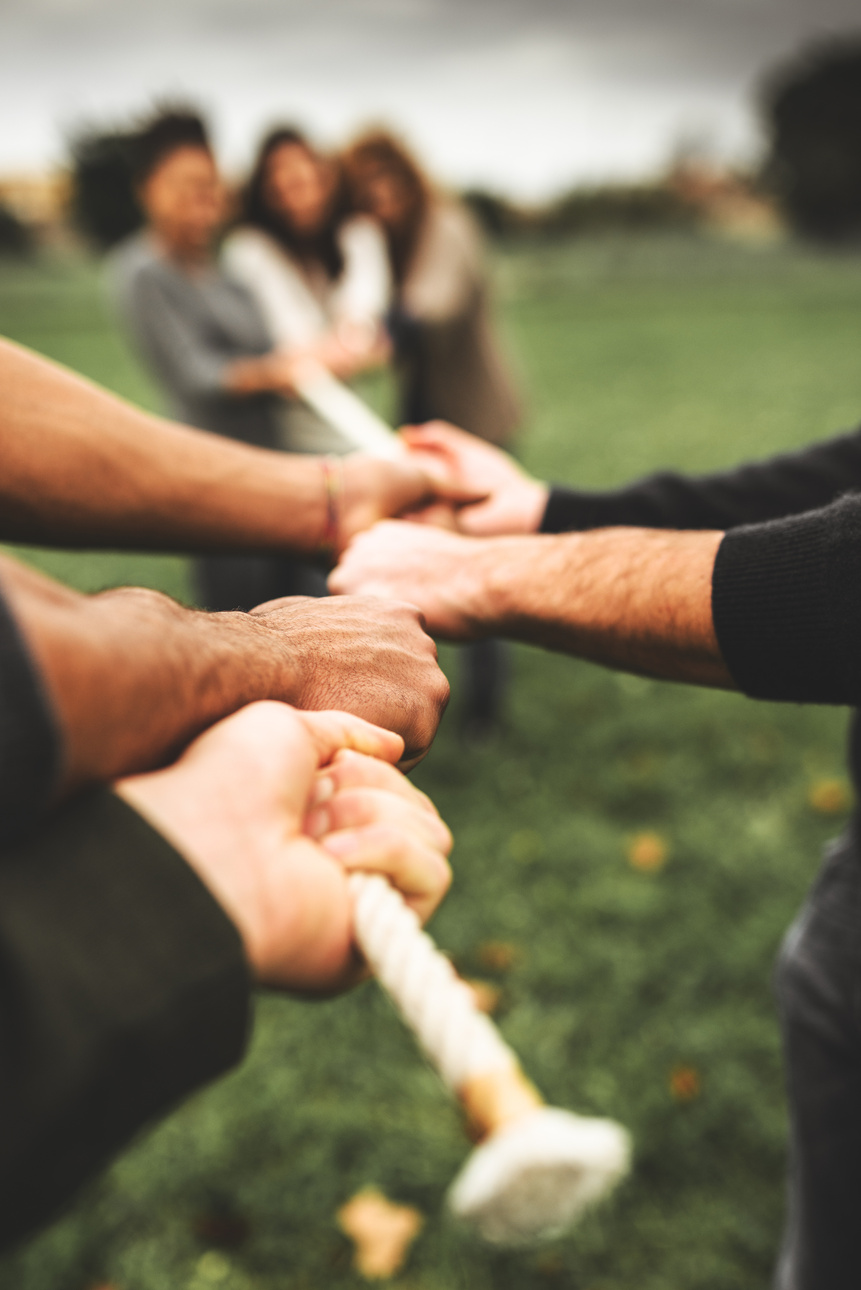 Friends doing the Tug of war - teamwork
